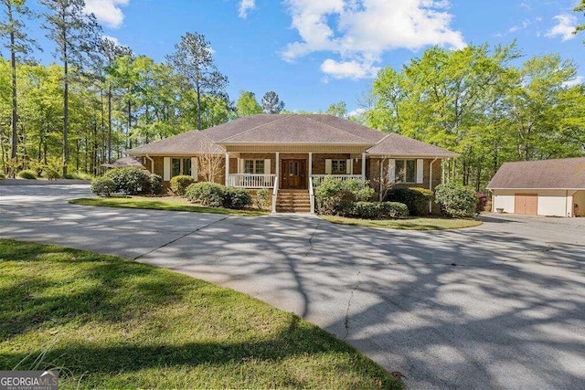 ranch-style house with an outbuilding and a porch