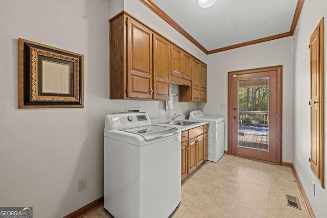 washroom with cabinets, ornamental molding, and sink