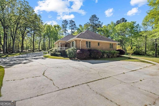 view of side of home with a yard