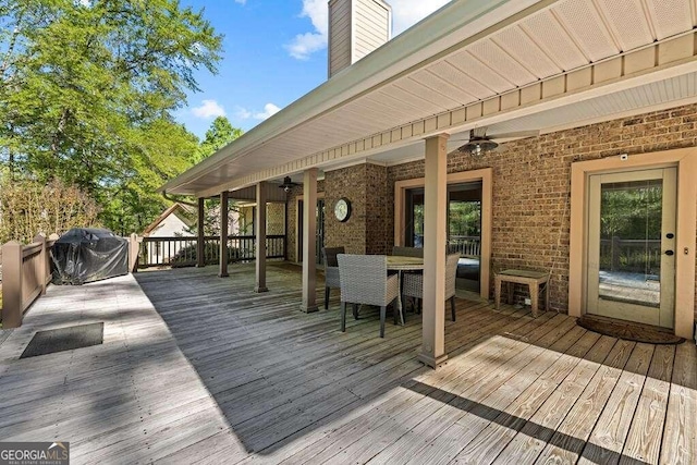 deck featuring area for grilling and ceiling fan