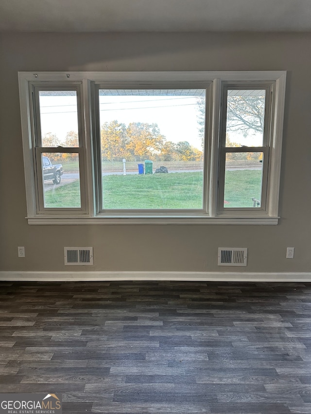 empty room featuring dark hardwood / wood-style flooring