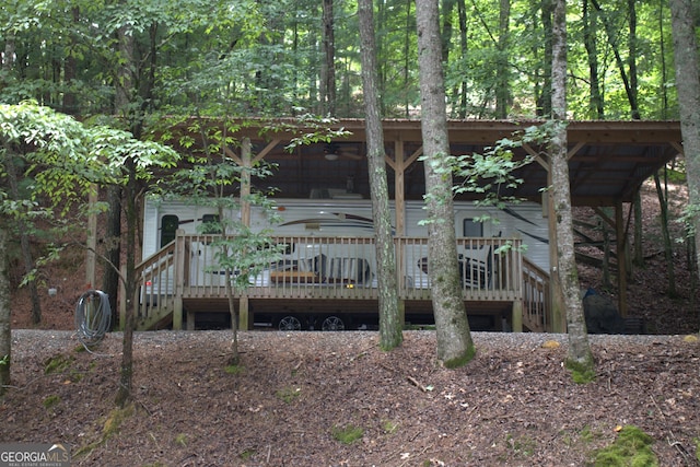 rear view of property with a wooden deck