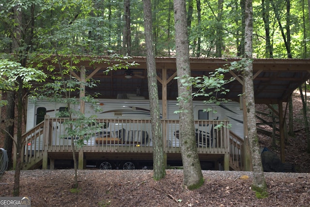 rear view of house featuring a deck