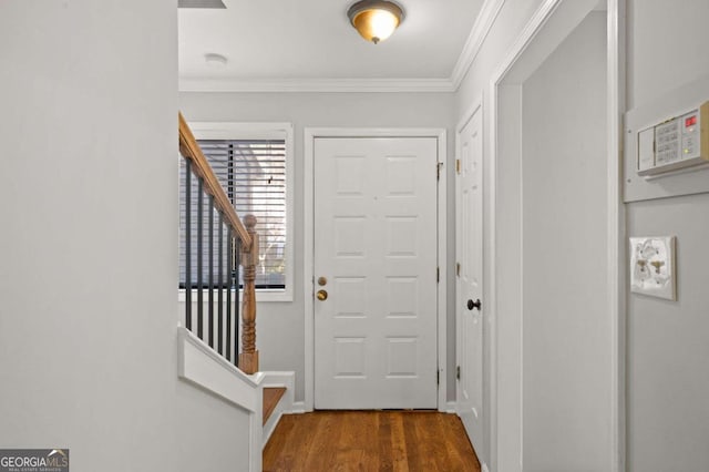 entryway with dark hardwood / wood-style flooring and ornamental molding