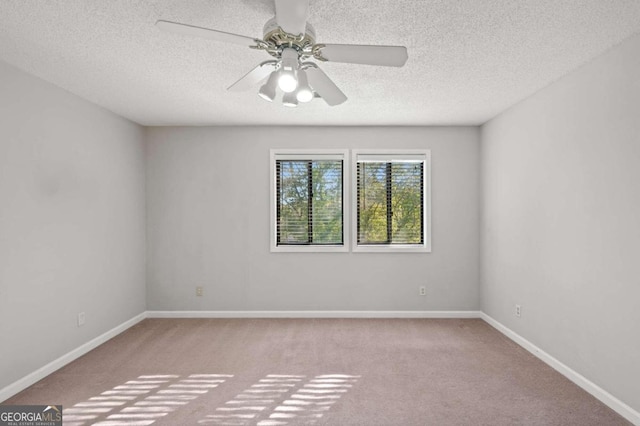 carpeted spare room with ceiling fan and a textured ceiling