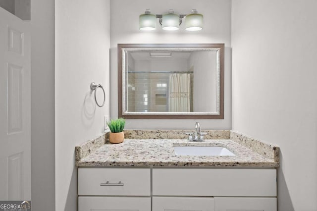 bathroom with a shower with shower curtain and vanity