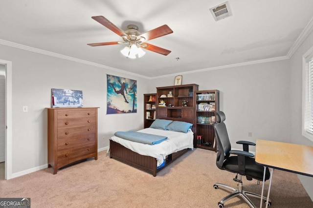 carpeted bedroom with ceiling fan and ornamental molding