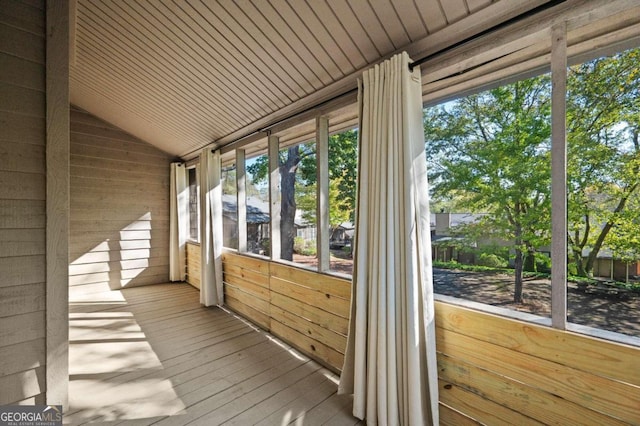 unfurnished sunroom with vaulted ceiling and wooden ceiling