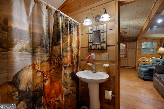 bathroom featuring wooden ceiling, wooden walls, wood-type flooring, and vaulted ceiling