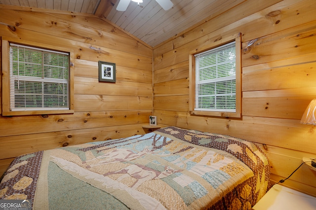 bedroom with wood walls, ceiling fan, wood ceiling, and vaulted ceiling