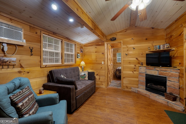 living room with vaulted ceiling with beams, wood walls, and light wood-type flooring