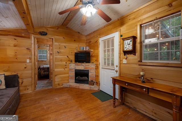 living room featuring hardwood / wood-style floors, wood ceiling, plenty of natural light, and wood walls