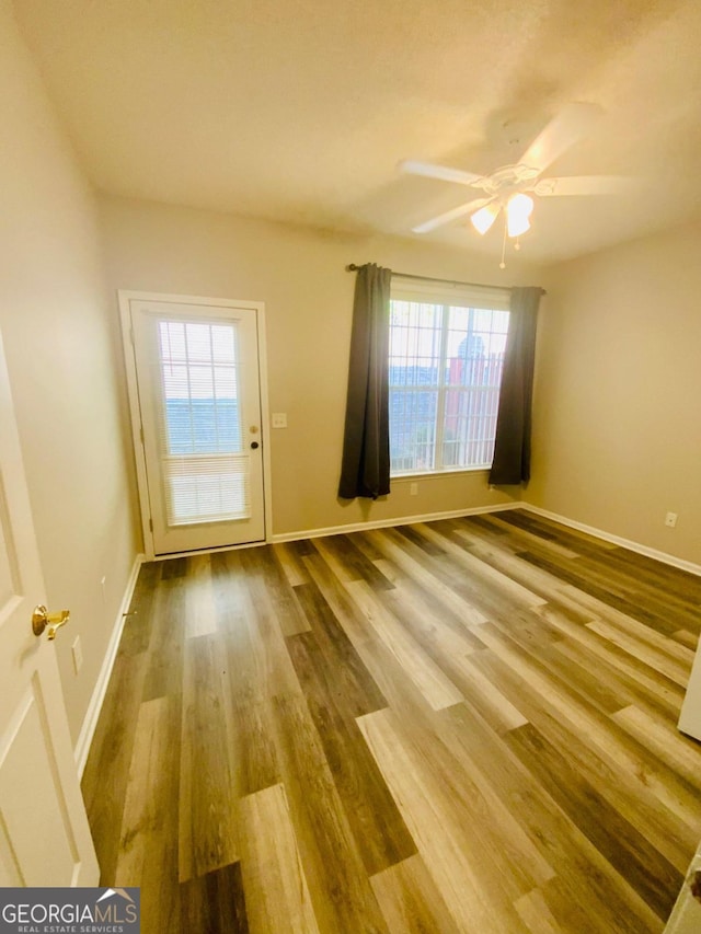 interior space featuring ceiling fan, a healthy amount of sunlight, and hardwood / wood-style flooring