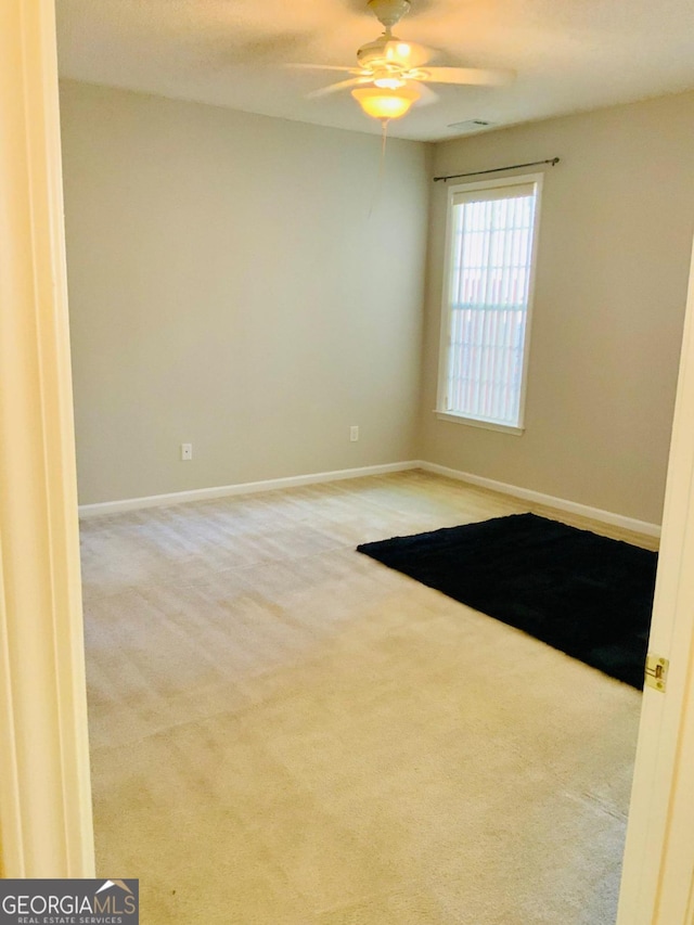 empty room with light carpet and ceiling fan