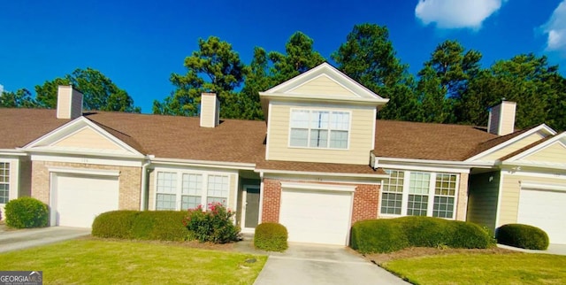 view of front of house with a front yard and a garage