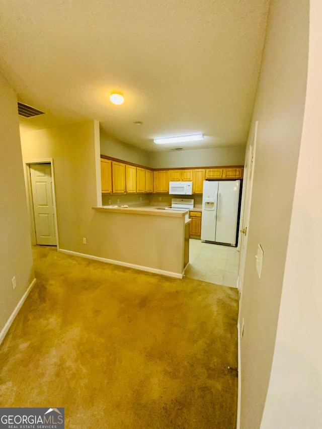 kitchen with a textured ceiling, kitchen peninsula, light colored carpet, and white appliances