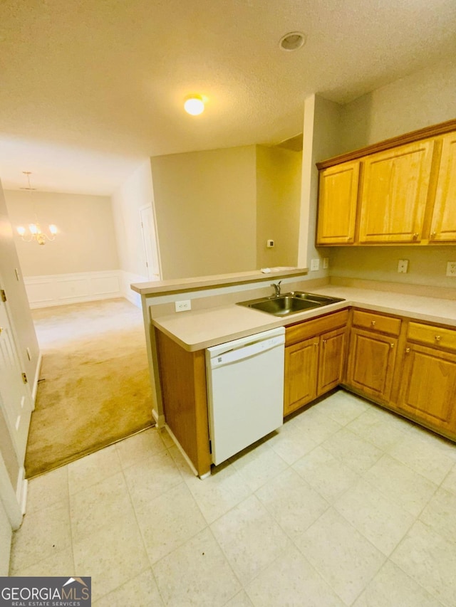 kitchen with pendant lighting, dishwasher, an inviting chandelier, sink, and light colored carpet