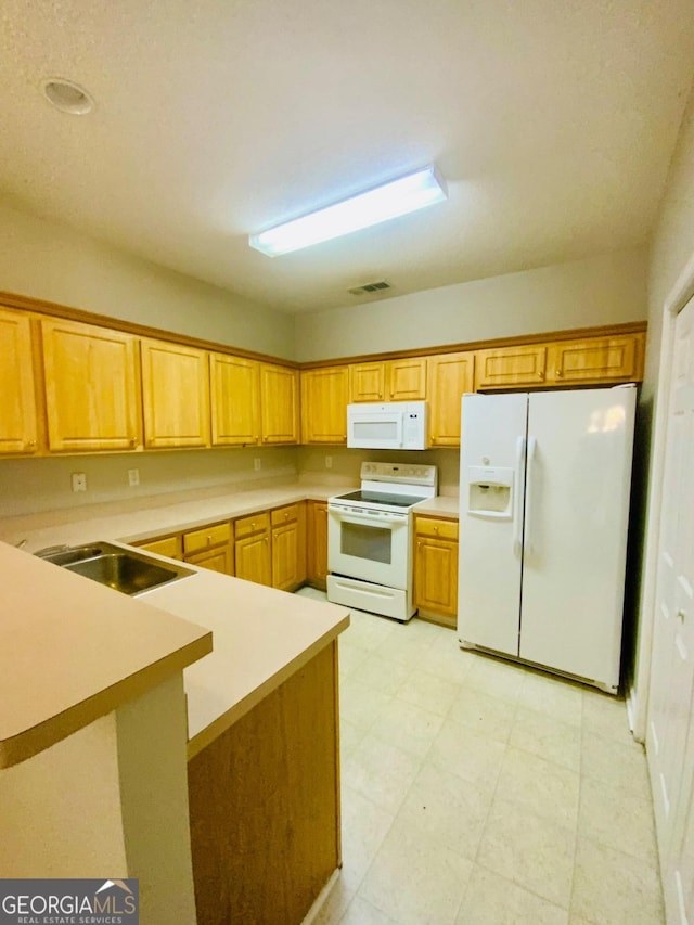 kitchen featuring white appliances and sink