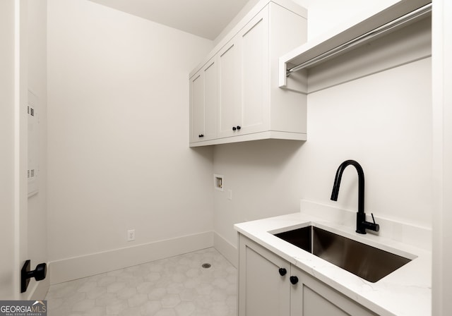 laundry area with cabinets, hookup for a washing machine, and sink