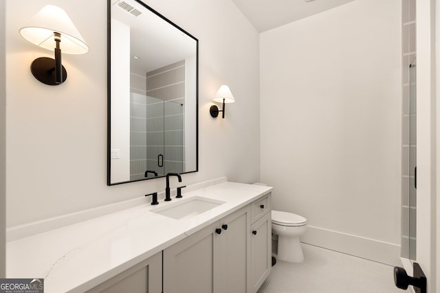 bathroom with vanity, a shower with door, tile patterned floors, and toilet