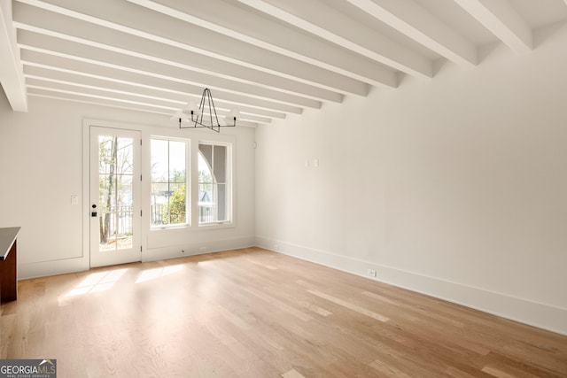 interior space with a notable chandelier, light hardwood / wood-style floors, and beamed ceiling