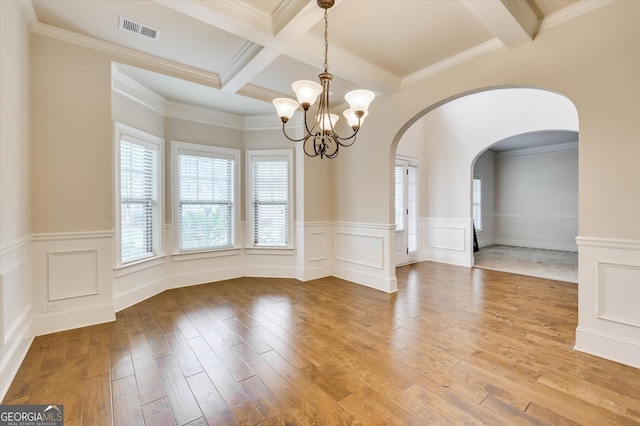 unfurnished dining area with hardwood / wood-style flooring, beam ceiling, ornamental molding, and coffered ceiling