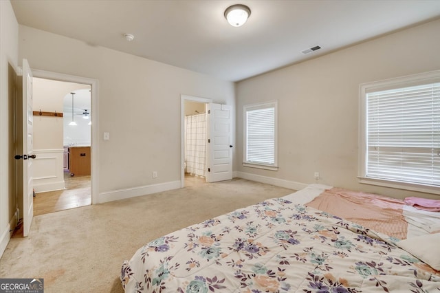 carpeted bedroom with ensuite bathroom