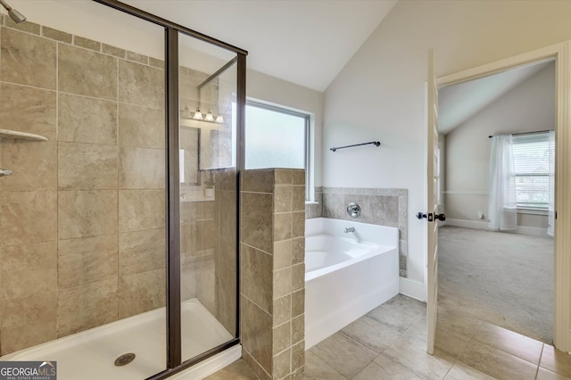 bathroom featuring tile patterned floors, lofted ceiling, and shower with separate bathtub