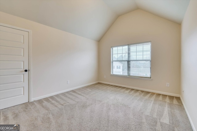 unfurnished room with carpet flooring and lofted ceiling