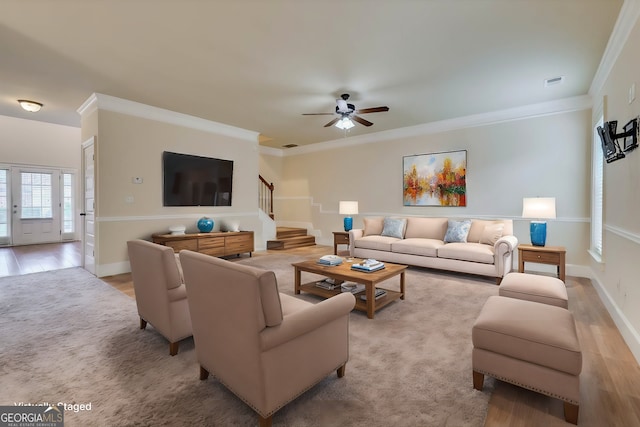 living room featuring ceiling fan, light hardwood / wood-style floors, and ornamental molding