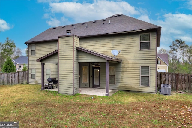 rear view of property featuring ceiling fan, a patio area, a yard, and central air condition unit