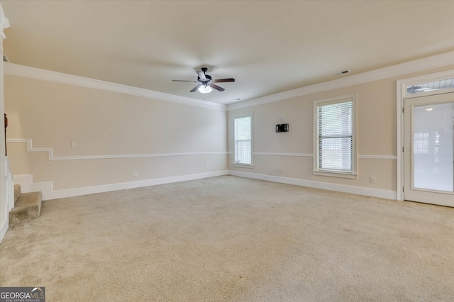 spare room with ceiling fan, light colored carpet, and ornamental molding