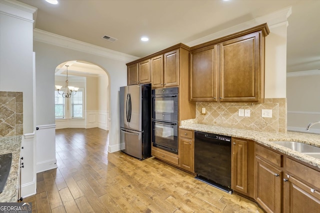 kitchen featuring black appliances, ornamental molding, sink, and light hardwood / wood-style flooring