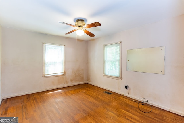 unfurnished room with ceiling fan and wood-type flooring