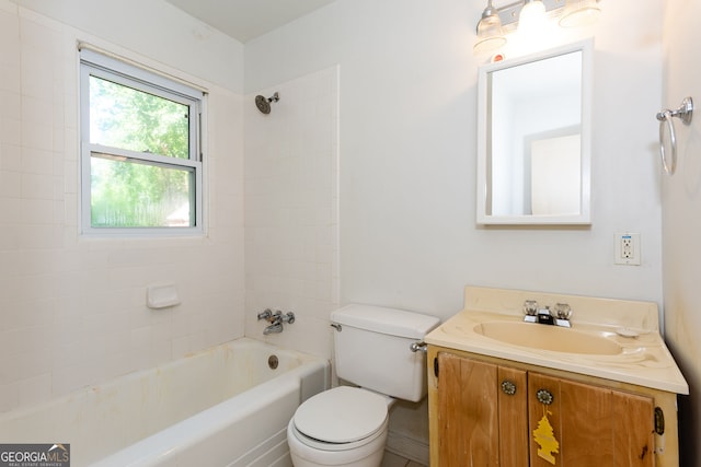 full bathroom with tiled shower / bath, vanity, and toilet