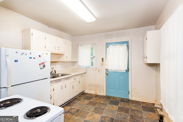 kitchen with white cabinetry, white appliances, and sink