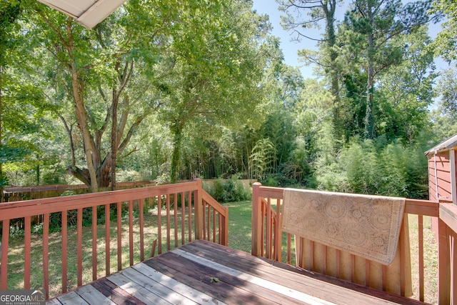 wooden terrace with a yard