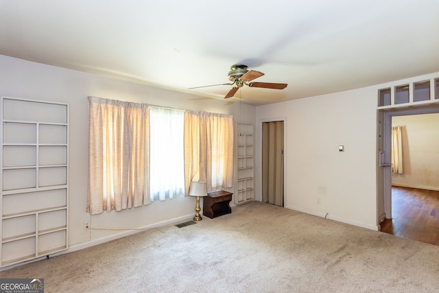 empty room with hardwood / wood-style floors and ceiling fan