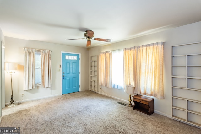 interior space featuring ceiling fan and carpet