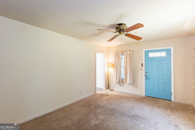 carpeted entrance foyer featuring ceiling fan