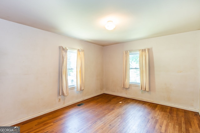 spare room featuring wood-type flooring