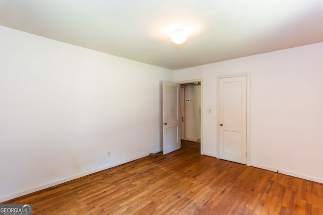 unfurnished room featuring wood-type flooring