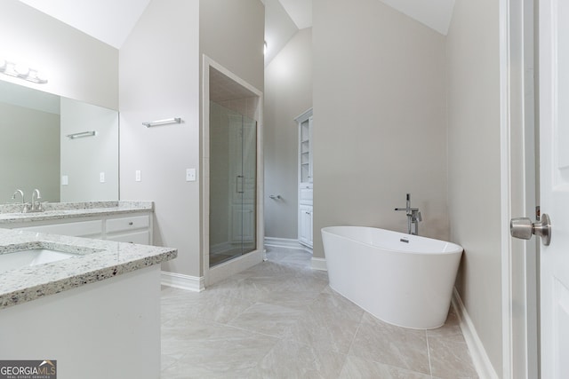 bathroom with vanity, lofted ceiling, and independent shower and bath