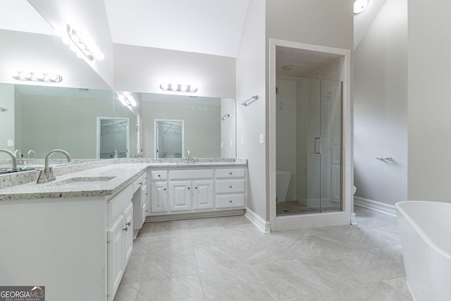 1510 Natchez Way, Grayson, GA 30017 - full bath with double vanity, a stall shower, a freestanding tub, marble look tile flooring, and baseboards