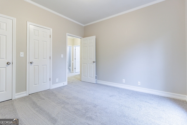 unfurnished bedroom featuring ornamental molding and light carpet