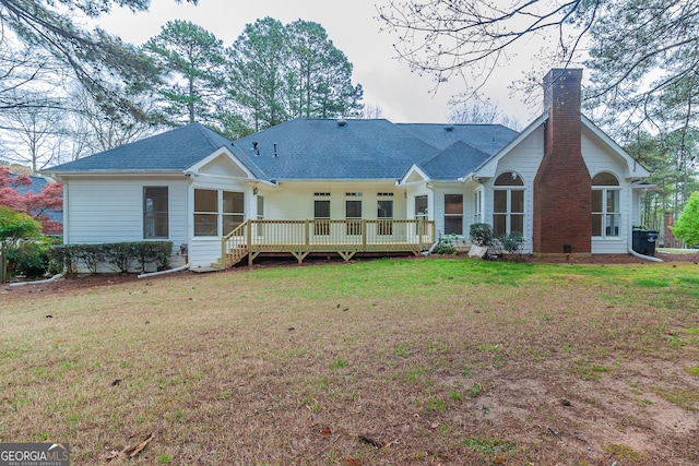 back of property featuring a yard and a wooden deck