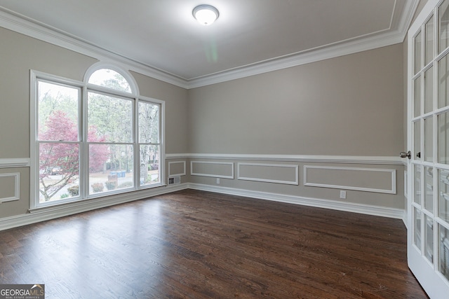 unfurnished room featuring ornamental molding and dark wood-type flooring