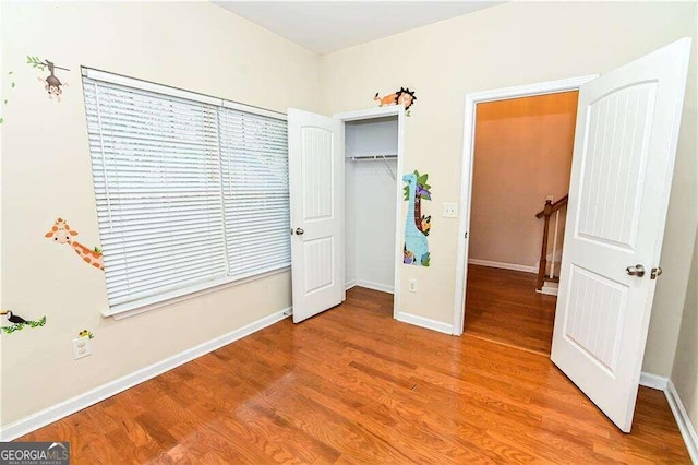 unfurnished bedroom with a closet and light hardwood / wood-style flooring