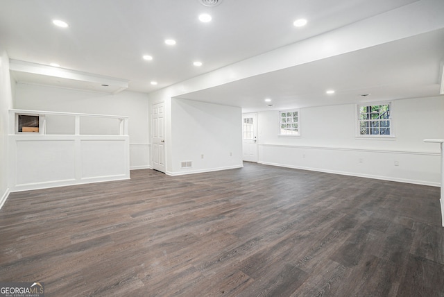 unfurnished living room featuring dark wood-type flooring