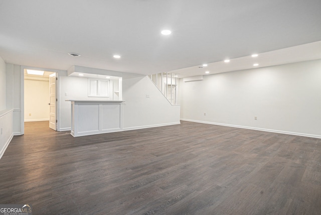 basement with dark hardwood / wood-style flooring